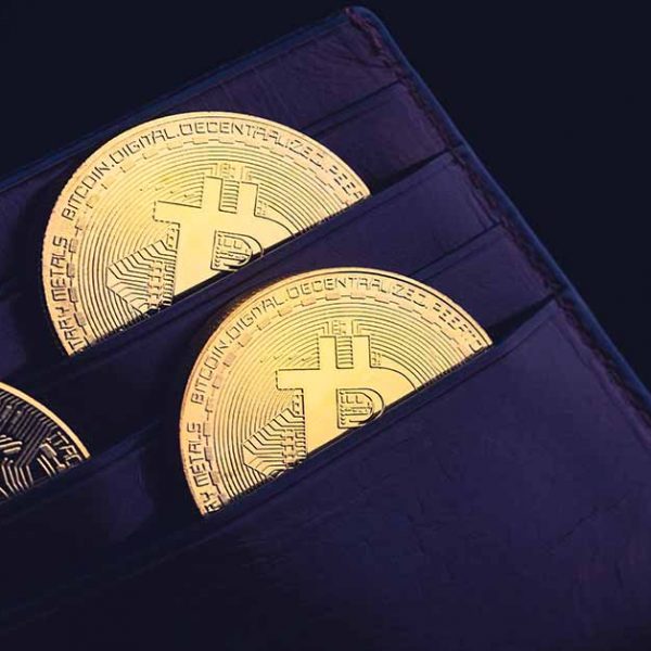 side view closeup concept of bitcoin cryptocurrency golden coins in leather black money wallet
